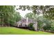 A spacious backyard with mature trees and lush lawn has an oversized deck for outdoor living at 3750 Cannonwolde Dr, Snellville, GA 30039