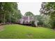 Expansive backyard with lush green lawn and mature trees provides a private and serene oasis at 3750 Cannonwolde Dr, Snellville, GA 30039
