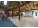 Unfinished basement with concrete floor, exposed ceiling and multiple garage doors at 3750 Cannonwolde Dr, Snellville, GA 30039