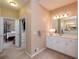 Bathroom with double sinks, white cabinetry and an open doorway leading to the bedroom at 3750 Cannonwolde Dr, Snellville, GA 30039