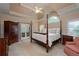 A bedroom features a four poster bed, sitting area and french doors at 3750 Cannonwolde Dr, Snellville, GA 30039