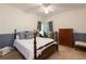 Bedroom features a four-poster bed, cool color palette and ceiling fan at 3750 Cannonwolde Dr, Snellville, GA 30039