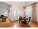 Formal dining area with large windows, hardwood floors, and elegant chandelier at 3750 Cannonwolde Dr, Snellville, GA 30039