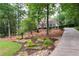 Well-maintained home with a long driveway, landscaped gardens and mature trees at 3750 Cannonwolde Dr, Snellville, GA 30039