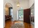 Elegant foyer features hardwood floors, chandelier, and arched entryways at 3750 Cannonwolde Dr, Snellville, GA 30039