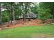Landscaped front yard with mature trees and lush green lawn provides excellent curb appeal at 3750 Cannonwolde Dr, Snellville, GA 30039