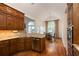 Charming kitchen with wood cabinets, granite countertops, stainless steel appliances, and hardwood floors at 3750 Cannonwolde Dr, Snellville, GA 30039