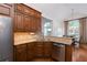 Lovely kitchen with wood cabinets, granite countertops, stainless steel appliances, and hardwood floors at 3750 Cannonwolde Dr, Snellville, GA 30039
