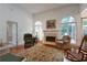 Sunlit living room with cozy seating, fireplace and hardwood floors at 3750 Cannonwolde Dr, Snellville, GA 30039