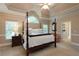 Spacious main bedroom with vaulted ceiling, four-poster bed, and ensuite bathroom at 3750 Cannonwolde Dr, Snellville, GA 30039