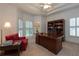 Home office with dark wood desk, plush seating, and built in bookcase at 3750 Cannonwolde Dr, Snellville, GA 30039