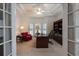 A view into the office features a large desk, bookcase and comfortable seating at 3750 Cannonwolde Dr, Snellville, GA 30039