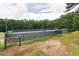 A private tennis club offers well-maintained courts surrounded by mature trees and landscaping at 3750 Cannonwolde Dr, Snellville, GA 30039