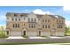 Charming townhome featuring brick facade, gray trim, individual garages, and welcoming entrances at 517 Provence Gate Ln, Lawrenceville, GA 30044
