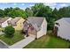 Aerial view of a well-maintained house with a green lawn and driveway at 6175 Beaver Crossing Dr, Cumming, GA 30040