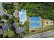 Aerial view of community pool, tennis courts, playground, and surrounding greenery at 6175 Beaver Crossing Dr, Cumming, GA 30040
