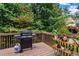 Back deck view featuring a grill, wooden railing, and potted plants at 6175 Beaver Crossing Dr, Cumming, GA 30040