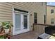 Back door and deck space, featuring a grill and potted plants at 6175 Beaver Crossing Dr, Cumming, GA 30040