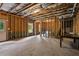 Unfinished basement area with exposed framing and walkout door at 6175 Beaver Crossing Dr, Cumming, GA 30040
