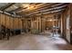 Large unfinished basement featuring exposed beams and concrete flooring at 6175 Beaver Crossing Dr, Cumming, GA 30040