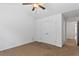 Neutral bedroom with a ceiling fan, large closet, and carpet floors at 6175 Beaver Crossing Dr, Cumming, GA 30040