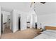 Bright bedroom featuring neutral carpet and walls, with views to bathroom at 6175 Beaver Crossing Dr, Cumming, GA 30040