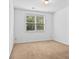 Neutral bedroom with a carpet floors and a window with blinds at 6175 Beaver Crossing Dr, Cumming, GA 30040