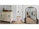 Bright bedroom featuring an antique dresser with mirror and a peek into the ensuite bathroom at 6175 Beaver Crossing Dr, Cumming, GA 30040