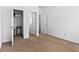 Bedroom featuring carpet flooring, white walls, and a walk-in closet at 6175 Beaver Crossing Dr, Cumming, GA 30040