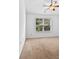 Neutral bedroom with a ceiling fan, large window, and carpet floors at 6175 Beaver Crossing Dr, Cumming, GA 30040