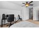 Bedroom with neutral walls and carpet, featuring ceiling fan and desk space at 6175 Beaver Crossing Dr, Cumming, GA 30040