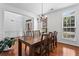 Bright dining area featuring a chandelier, hardwood floors, and natural light at 6175 Beaver Crossing Dr, Cumming, GA 30040