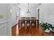 Traditional dining room featuring hardwood floors and a decorative chandelier with seating for six at 6175 Beaver Crossing Dr, Cumming, GA 30040