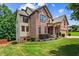 Spacious two-story home featuring a brick facade, lush lawn, and mature trees at 6175 Beaver Crossing Dr, Cumming, GA 30040