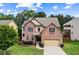 Charming two-story brick home with manicured lawn and attached two-car garage at 6175 Beaver Crossing Dr, Cumming, GA 30040