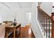 Foyer featuring hardwood floors, craftsman trim, and a staircase with iron spindles at 6175 Beaver Crossing Dr, Cumming, GA 30040
