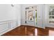 Elegant foyer with hardwood floors, white wainscoting, and a door with sidelights at 6175 Beaver Crossing Dr, Cumming, GA 30040