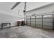Spacious garage with concrete floor, overhead door, and natural light at 6175 Beaver Crossing Dr, Cumming, GA 30040