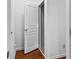 Hallway view featuring open closet or storage space and wood flooring at 6175 Beaver Crossing Dr, Cumming, GA 30040
