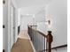 Upstairs hallway featuring fresh paint, wood and metal railings, carpet and access to several rooms at 6175 Beaver Crossing Dr, Cumming, GA 30040