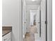 Hallway with tile flooring, white trim, and multiple doorways at 6175 Beaver Crossing Dr, Cumming, GA 30040