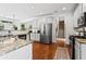 Modern kitchen with stainless steel appliances, granite countertops, and hardwood floors at 6175 Beaver Crossing Dr, Cumming, GA 30040