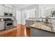 Well-lit kitchen features stainless steel appliances, granite countertops, and hardwood floors at 6175 Beaver Crossing Dr, Cumming, GA 30040