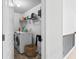 Well-lit laundry room with washer, dryer, shelving, and storage basket at 6175 Beaver Crossing Dr, Cumming, GA 30040