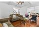 Open-concept living room with hardwood floors, comfortable seating, and seamless flow to the kitchen at 6175 Beaver Crossing Dr, Cumming, GA 30040