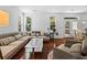 Comfortable living room with natural light, hardwood floors, and access to outdoor deck at 6175 Beaver Crossing Dr, Cumming, GA 30040