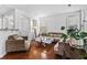 Cozy living room with large windows, hardwood floors, and a comfortable seating area at 6175 Beaver Crossing Dr, Cumming, GA 30040