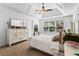 Bright main bedroom with a decorative ceiling fan and large windows for lots of sunlight at 6175 Beaver Crossing Dr, Cumming, GA 30040