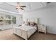 Main bedroom with trey ceiling, white furniture, and large windows at 6175 Beaver Crossing Dr, Cumming, GA 30040
