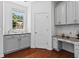 Walk-in pantry with granite countertops, custom cabinets, and hardwood floors at 6175 Beaver Crossing Dr, Cumming, GA 30040